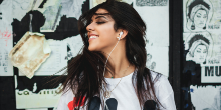 A woman listening to music and smiling