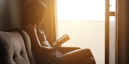 A woman relaxing reading a book